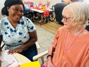 Resident and caregiver chatting together